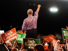 NDP Leader Jack Layton raises his cane to the crowd at a campaign rally in Burnaby, B.C. on Saturday, April 30, 2011. The federal election will be held on May 2. (THE CANADIAN PRESS/Andrew Vaughan)