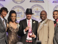 Kid Rock, center, holds the Great Expectations Award trophy while posing for photos with, from left, Robert Ritchie Jr., Shaun Robinson, host of Access Hollywood, NAACP Detroit Chapter President Wendell Anthony and Donnell White, Interim executive director of the Detroit branch of the NAACP, during the organization's annual fundraising dinner in Detroit, Sunday, May 1, 2011. Chapter leaders say Kid Rock, a Detroit area native whose real name is Robert Ritchie, is deserving of Sunday night's honor for his support of the city. (AP Photo/Carlos Osorio)