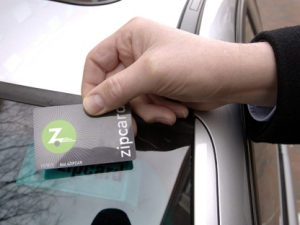Scott Griffith, CEO of Zipcar Inc., based in Cambridge, Mass., holds one of the electronic cards that customers swipe over a sensor behind the windshield to unlock the vehicles they have reserved in this 2007 file photo. (AP Photo/Josh Reynolds, file)