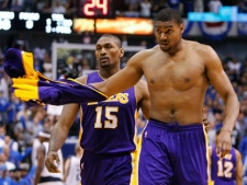 Los Angeles Lakers' Andrew Bynum, right, is escorted from the floor by teammate Ron Artest after Bynum was ejected for a flagrant foul during the second half of Game 4 of a second-round NBA playoff basketball series against the Dallas Mavericks, Sunday, May 8, 2011, in Dallas. The Mavericks won 122-86, sweeping the series. (AP Photo/Richard W. Rodriguez)