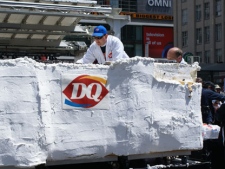 Staffers with Dairy Queen cut the world's largest ice-cream cake at Yonge-Dundas Square on May 10, 2011. (Chris Fox/CP24.com)
