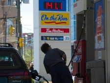 A man fills his vehicle with gas in Toronto on Wednesday, May 11, 2011. Gas prices around the GTA hit an all-time record high of 141.1. (THE CANADIAN PRESS/Nathan Denette)