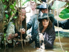 In this film publicity image released by Disney, Johnny Depp, left, Penelope Cruz, right, and Ian McShane, background are shown in a scene from, "Pirates of the Caribbean: On Stranger Tides." (AP Photo/Disney, Peter Mountain) 