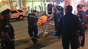 Paramedics transport a man after a shooting on King Street West early Friday, Aug. 9, 2013. (Tom Podolec/CTV)