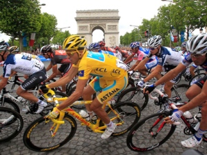 This July 25, 2010 file photo shows Alberto Contador, of Spain , wearing the overall leader's yellow jersey, riding past the Arc de Triomphe on the Champs Elysees during the 20th and last stage of the Tour de France cycling race, in Paris, France. (AP Photo/Christophe Ena, File)