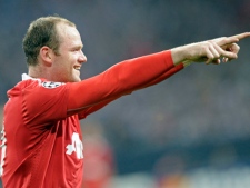 Manchester's Wayne Rooney celebrates after scoring his side's second goal during the the Champions League semifinal soccer match between FC Schalke 04 and Manchester United in Gelsenkirchen, Germany, Tuesday, April 26, 2011. (AP Photo/Martin Meissner)