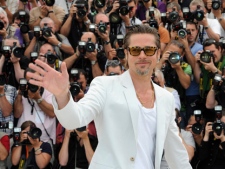Actor Brad Pitt waves during a photo call for The Tree of Life at the 64th international film festival, in Cannes, southern France, Monday, May 16, 2011. (AP Photo/Jonathan Short)