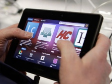 Jordi Valdes looks at a BlackBerry PlayBook tablet at a Best Buy store in San Francisco, Tuesday, April 19, 2011. (AP /Jeff Chiu)