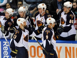 Atlanta Thrashers' Rob Schremp (13) and Evander Kane (9) celebrate Schremp's goal against the New York Islanders with teammates during the second period of an NHL hockey game Thursday, March 24, 2011, in Uniondale, N.Y. The owners of the Thrashers have reportedly begun negotiations on a sale that would relocate the team to Winnipeg. (THE CANADIAN PRESS/AP-Kathy Kmonicek)