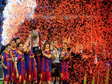 FC Barcelona players celebrate with the trophy after winning the Spanish League title during a Spanish La Liga soccer match against Deportivo Coruna at the Camp Nou stadium in Barcelona, Spain, Sunday, May 15, 2011. (AP Photo/Manu Fernandez)