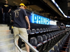 After purchasing his season tickets once again, Atlanta Thrashers fan Brett Buckwald, of Sandy Springs, Ga., looks back at the seat he has had since the first season of the franchise on Saturday, May 21, 2011, in Atlanta. (AP Photo/John Amis)
