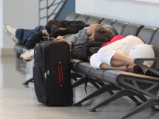 Passengers rest at the airport in Bremen northern Germany, Wednesday, May 25, 2011, after flights were canceled due to elevated levels of ash in the atmosphere stemming from an Icelandic volcano. (AP Photo/dapd, Joerg Sarbach)