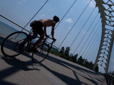 A cyclist crosses a bridge over the Humber River in Toronto, on Thursday, June 17, 2010. (Adrien Veczan / THE CANADIAN PRESS)