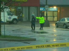 Toronto police officers at the scene of a homicide at Finch Avenue East and Victoria Park Avenue. A 21-year-old man was fatally shot Thursday, May 26, 2011.  