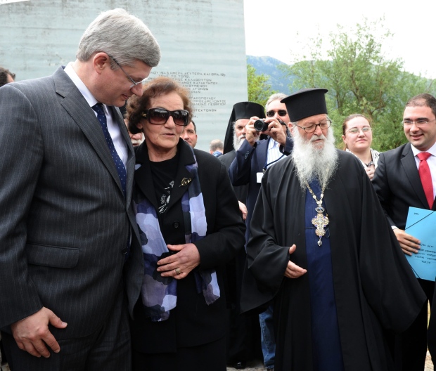 Prime Minister Stephen Harper, left, talks with Amalia Spiropoulou, aunt of Harper's Director of Communications, Dimitri Soudas, right, after taking part in a ceremony at the memorial site of the Kalavryta Massacre in Kalavryta Greece, on Sunday, May 29, 2011. On Dec. 13, 1943, Nazi troops executed 696 males over the age of 14 in Kalavryta. (THE CANADIAN PRESS/Sean Kilpatrick)