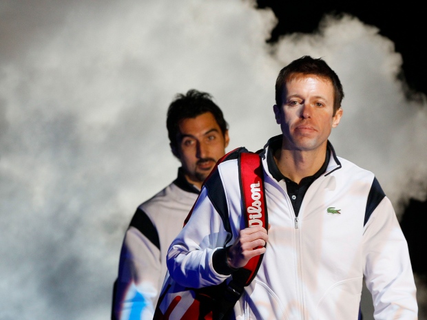 Canada's Daniel Nestor, right, and Serbia's Nenad Zimonjic arrive on court to face India's Mahesh Bhupathi and Max Mirnyi of Belarus in the doubles final tennis match at the ATP World Tour Finals at the O2 Arena in London, Sunday, Nov. 28, 2010. (AP Photo/Kirsty Wigglesworth)