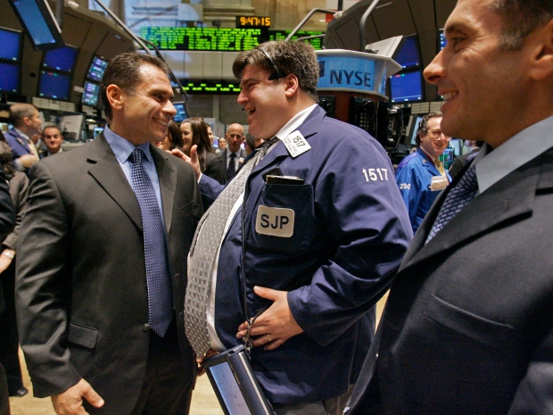 Winners of the NBC "Biggest Loser" television show Jim Germanakos, left, and his brother Bill Germanakos, right, meet New York Stock Exchange floor trader Steve Perciballi after the brothers rang the NYSE opening bell, Thursday Jan. 3, 2007. (AP Photo/Richard Drew)