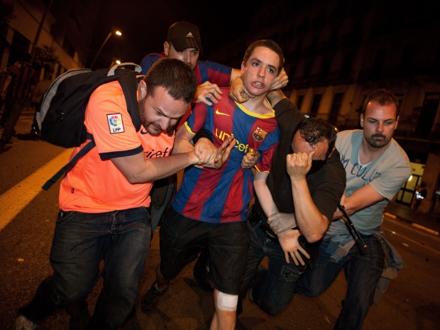 A supporter from Barcelona F.C is arrested by plain clothes police officers during clashes following the Champions League final soccer match in London against Manchester United in Barcelona, Sunday, May 29, 2011. (AP Photo/Job Vermeulen)