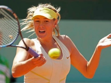 Maria Sharapova of Russia returns against Andrea Petkovic of Germany in the quarter final match of the French Open tennis tournament in Roland Garros stadium in Paris, Wednesday June 1, 2011. (AP Photo/Lionel Cironneau)