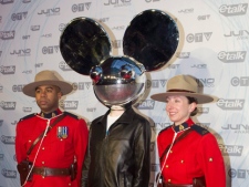 Deadmau5 poses with two Mounties as he arrives at the Juno Awards in Toronto on Sunday March 27, 2011. THE CANADIAN PRESS/Chris Youngcp