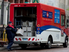 A postal worker loads his vehicle in Halifax on Monday, May 30, 2011. (THE CANADIAN PRESS/Andrew Vaughan)