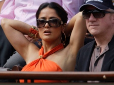 Mexican-born actress Salma Hayek, left, and Francois-Henri Pinault, right, watch Rafael Nadal of Spain and Andy Murray of Britain in the semi final match of the French Open tennis tournament in Roland Garros stadium in Paris, Friday June 3, 2011. (AP Photo/Lionel Cironneau)
