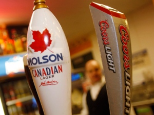 Molson and Coors taps are seen at a vending stand on the concourse of the Pepsi Center before the Colorado Avalanche hosted the Calgary Flames in an NHL game in Denver on Monday, Nov. 5, 2007. (AP Photo/David Zalubowski)