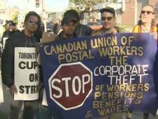 Members of the Canadian Union of Postal Workers picket outside a Canada Post facility in Toronto Wednesday, June 15, 2011.  