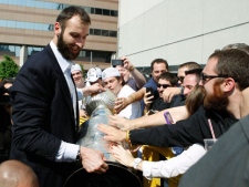 Boston Bruins captain Zdeno Chara, left, of Slovakia, lets fans touch the Stanley Cup upon the team's return to Boston, Thursday, June 16, 2011. The Bruins won the NHL hockey Stanley Cup Wednesday night beating the Vancouver Canucks 4-0 in Game 7 in Vancouver, British Columbia. (AP Photo/Bizuayehu Tesfaye)
