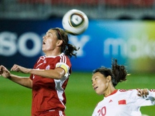 Canada's Christine Sinclair, left, heads the ball past China PR's Gaoping Zhou, right, during women's international friendly soccer match action in Toronto on Thursday, September 30, 2010. Canada's prolific striker Sinclair and veteran goalkeeper Karina LeBlanc headline the team's roster for the women's World Cup. (THE CANADIAN PRESS/Nathan Denette)