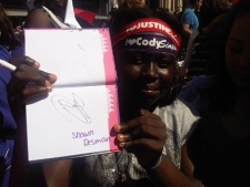 Tara, 13, holds up her favourite autograph -- one by Shawn Desman -- ahead of the MMVAs on June 19, 2011. (Sandie Benitah/CP24.com)