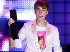 Justin Bieber receives an award on stage during the 2011 MuchMusic Video Awards in Toronto on Sunday, June 19, 2011. THE CANADIAN PRESS/Darren Calabrese