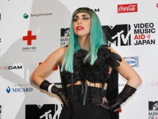 Lady Gaga poses with a "We pray for Japan" wrist band during a press conference to promote MTV Video Music Aid Japan in Tokyo Thursday, June 23, 2011. Lady Gaga is in Japan to attend the MTV event to help support people in the tsunami-hit northeastern Japan. (AP Photo/Shizuo Kambayashi)