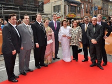 Family of famed Bollywood star Raj Kapoor (left to right) sons Rishi Kapoor, Rajiv Kapoor, Randhir Kapoor, Ritu Nanda (daughter), Premier Dalton McGuinty, his widow Krishna Raj Kapoor, Reema Jain (daughter), Manoj Jain (son-in-law), actor and host Anupam Kher, and TIFF's Noah Cowan stand for a photo on the red carpet during the Raj Kapoor Family Tribute event on Sunday, June 26, 2011 during the IIFA Film Festival at the TIFF Bell Light Box in Toronto. (THE CANADIAN PRESS/Aaron Vincent Elkaim)