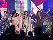 From left to right, Diya Mirza, Priyanka Chopra, Anushka Sharma, and Shah Rukh Khan acknowledge the fans while on stage at the end of the 2011 International Indian Film Academy Awards in Toronto early Sunday morning, June 26, 2011. (AP Photo/The Canadian Press - Chris Young)
