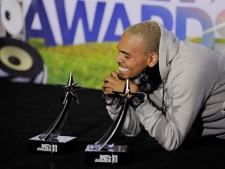 Chris Brown poses backstage after winning the awards for best male R&B artist and best collaboration for "Look at Me Now" featuring Lil Wayne and Busta Rhymes at the BET Awards on Sunday, June 26, 2011, in Los Angeles. (AP Photo/Chris Pizzello)