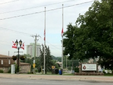 Flags fly at half-mast outside the York Regional Police 1 District headquarters after one of the service's officers was killed in a collision Tuesday, June 28, 2011. (CP24/Tom Stefanac)