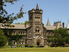 People walk past University College, built in 1858, on the University of Toronto's campus Thursday, June 30, 2011. (CP24/Chris Kitching)