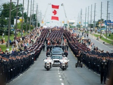 York Regional Police accompanied by GTA Police, OPP, Fire and Emergency Medical Service workers are seen on Yonge Street in Newmarket, Ont., during the funeral procession for Constable Garrett Styles on Tuesday, July 5, 2011. Constable Styles died in the line of duty on Tuesday, June 28, 2011, in the town of East Gwillimbury. THE CANADIAN PRESS/Aaron Vincent Elkaim