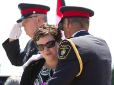 Melissa Styles, centre, the wife of slain York Regional Police Officer Constable Garrett Styles, receives condolences upon arriving for her husband's remembrance service at the Ray Twinney Complex in Newmarket, Ontario Tuesday July 5, 2011. THE CANADIAN PRESS/Darren Calabrese