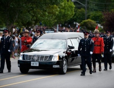 The hearse carrying Constable Garrett Styles proceeds down Eagle Street during his funeral procession in Newmarket on Tuesday, July 5, 2011. Constable Styles died in the line of duty on Tuesday, June 28, 2011, in the town of East Gwillimbury. THE CANADIAN PRESS/Aaron Vincent Elkaim