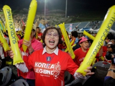 South Koreans support for Pyeongchang's bid to host the 2018 Winter Games in front of a ski jumping hill in Pyeongchang, South Korea, Wednesday, July 6, 2011. The three cities Munich, Annecy, and Pyeongchang, vying for the 2018 Winter Olympics are making their final pitches in a contest between a third-time Asian bid from South Korea and two European challengers. The IOC will vote by secret ballot, with the winner expected to be announced after 11 a.m. EDT. (AP Photo/Lee Jin-man)