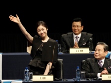 South Korea Olympic figure champion Yu-Na Kim, center, waves as she acknowledges applause at the start of the presentation at the 123rd IOC session in support of Pyeongchang's bid to host the 2018 Winter Games in Durban, South Africa, Wednesday July 6, 2011. The International Olympic Committee will announce the host city for the 2018 Winter Olympics in Durban. The IOC members will choose between three candidates Annecy, France; Munich Germany; and Pyeongchang, South Korea for the 2018 host. (AP Photo/Themba Hadebe)
