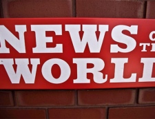 A News of the World sign is seen by an entrance to a News International building in London, Wednesday, July 6, 2011. (AP / Matt Dunham)