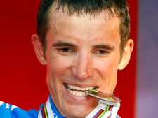 This is a Sunday, Sept. 27, 2009 file photo of Russia's Alexandr Kolobnev as he bites the silver medal of the Men's race, at the UCI road cycling World Championships in Mendrisio, Switzerland. Kolobnev became the first cyclist at this year's Tour de France to fail a doping test, the International Cycling Union said Monday July 11. 2011. (AP Photo/Alessandro Trovati)