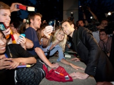 Actor Matthew Lewis, right, who plays the character Neville Longbottom in the Harry Potter films, poses with fans following the Canadian premiere of "Harry Potter and the Deathly Hallows: Part 2" in Toronto Tuesday, July 12, 2011. (THE CANADIAN PRESS/Darren Calabrese)