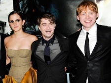 Cast members, from left, Emma Watson, Daniel Radcliffe and Rupert Grint pose together at the premiere of "Harry Potter and the Deathly Hallows: Part 2" at Avery Fisher Hall on Monday, July 11, 2011 in New York. (AP Photo/Evan Agostini)