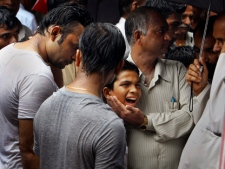 Relatives and friends console Vipin Soni, center, as he breaks down during the cremation of his brother Pankaj Soni, a bomb blast victim of Wednesday's Zaveri bazaar explosion in Mumbai, India, Thursday, July 14, 2011. Indian police are looking into "every possible hostile group" in their search for the culprits behind the triple bombing in the heart of Mumbai, the country's top security official said Thursday. (AP Photo/Aijaz Rahi)