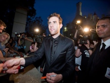 Actor Matthew Lewis, who plays the character Neville Longbottom in the Harry Potter films, signs autographs for fans following the Canadian premiere of "Harry Potter and the Deathly Hallows: Part 2" in Toronto Tuesday, July 12, 2011. (THE CANADIAN PRESS/Darren Calabrese)