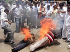 Activists of Bharatiya Janata Yuva Morcha (BJYM) burn effigies of Ajmal Kasab and Afzal Guru while demanding their hanging, during a demonstration against terrorism in Hyderabad, India, Tuesday, July 19, 2011. Kasab is the only surviving gunman from the 2008 attacks on Mumbai and Guru was convicted in the 2001 attack on parliament that killed 14 people. (AP Photo/Mahesh Kumar A.)